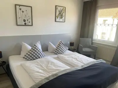 Ein Bett oder Betten in einem Zimmer der Unterkunft Harzhotel Warnstedter Krug