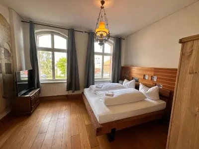 Ein Bett oder Betten in einem Zimmer der Unterkunft Altstadthotel Ilsenburg