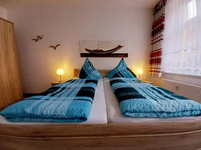 Ein Bett oder Betten in einem Zimmer der Unterkunft Ferienwohnung Neuer Weg 15