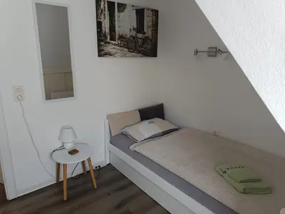 Ein Bett oder Betten in einem Zimmer der Unterkunft Ferienwohnung Harz Valley -Mit Fernblick in den Harz.