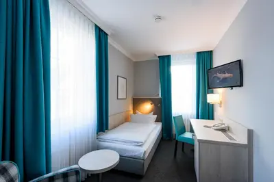 Ein Bett oder Betten in einem Zimmer der Unterkunft Hotel Braunschweiger Hof