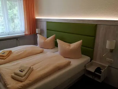 Ein Bett oder Betten in einem Zimmer der Unterkunft Gästehaus Tanne des DGD e.V.