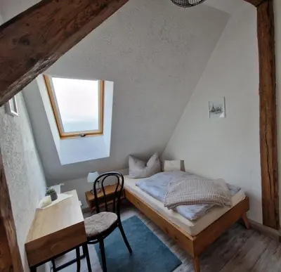 Ein Bett oder Betten in einem Zimmer der Unterkunft Pension Zum Lukullus