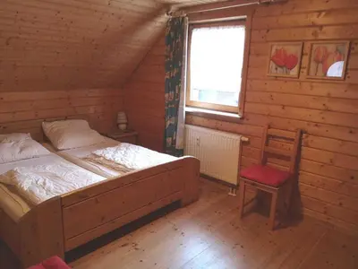 Ein Bett oder Betten in einem Zimmer der Unterkunft Holzferienhäuser im Naturerlebnisdorf Blauvogel
