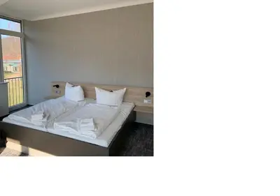 Ein Bett oder Betten in einem Zimmer der Unterkunft K6 Seminarhotel