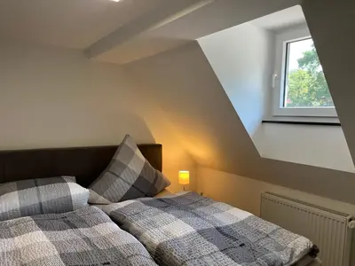 Ein Bett oder Betten in einem Zimmer der Unterkunft Ellas Ferienhaus