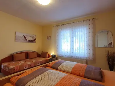 Ein Bett oder Betten in einem Zimmer der Unterkunft Ferienhaus Müller