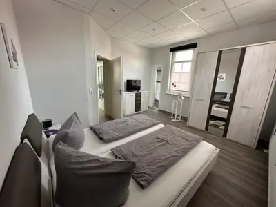 Ein Bett oder Betten in einem Zimmer der Unterkunft Sonneneck Ferienwohnungen adults only