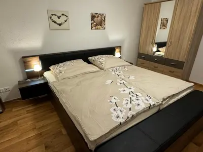 Ein Bett oder Betten in einem Zimmer der Unterkunft Ferienwohnung Le Petit